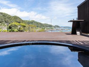 a swimming pool with a view of the ocean at Lost Cabin - Vacation STAY 89724v in Kamogawa