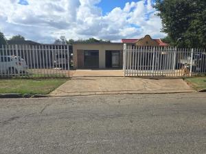 a white picket fence in front of a house at Cooperville 1 in Potchefstroom