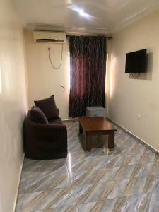 a living room with a couch and a coffee table at Luxritel Hotel Abuja in Kajewole