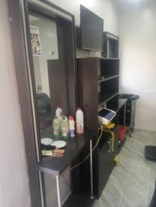 a kitchen with a counter with bottles on it at Luxritel Hotel Abuja in Kajewole