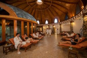 a group of people sitting in chairs in a building at Hotel Piroska in Bük