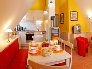 a kitchen with a table with food on it at SEETELHOTEL Nautic Usedom Dünenhäuser in Ueckeritz