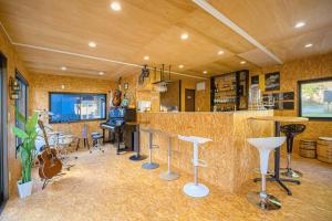 a bar with tables and stools in a room at Camp studio - Vacation STAY 89015v in Ichihara