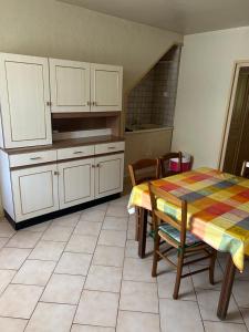 a kitchen with a table and a table and chairs at LEMAFIOlY in Cemboing
