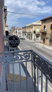 a sign on a railing on a city street at Residenze Candida - Casa Bianca in Locri