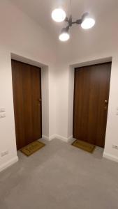 two doors in an empty room with at Residenze Candida - Casa Bianca in Locri