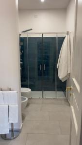 a bathroom with a glass shower and a toilet at Residenze Candida - Casa Bianca in Locri