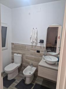 a bathroom with a toilet and a sink and a mirror at Villa le dalie in Mascalucia +27 photos