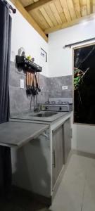 a kitchen with a sink and a stove at Kai Ecoglamping in El Peñol +14 photos