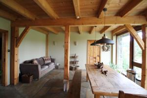 a living room with a wooden table and a couch at Beautiful Stone Riverside Retreat Galway in Galway