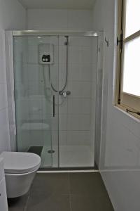 a shower with a glass door in a bathroom at Chris House in Nicosia