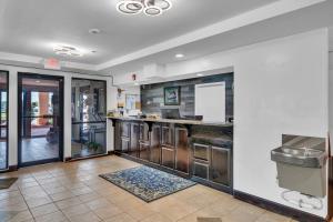 a kitchen with stainless steel appliances and a counter at Gray Inn & Suites in Gray