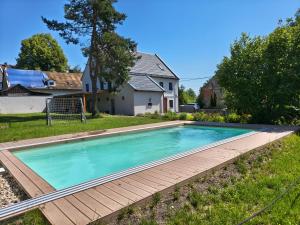 a swimming pool in the yard of a house at Chalupa Velká Javorská in Žandov