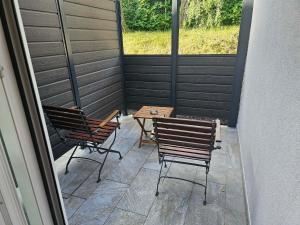 two chairs and a table on a patio at Zasavski Gurman in Dol pri Hrastniku