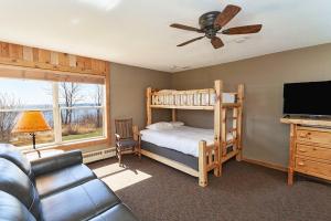 a bedroom with a bunk bed and a couch at Cove Point Lodge in Beaver Bay +41 photos
