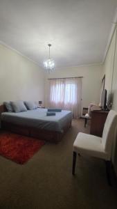 a bedroom with a bed and a couch and a chair at Oliveirinha, Aveiro, Portugal in Oliveirinha