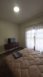a bedroom with a large bed and a television at Oliveirinha, Aveiro, Portugal in Oliveirinha