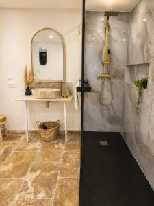 a bathroom with a sink and a mirror at Suite avec jacuzzi DOLCE NOTTE in Rochegude