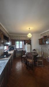 a kitchen with a table and a dining room at Oliveirinha, Aveiro, Portugal in Oliveirinha +14 photos