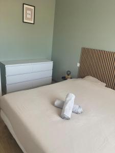 a bedroom with a bed with a towel on it at Maison chaleureuse in Migron
