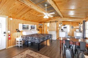 a bedroom with a bed and a table and a kitchen at Historic Rockaway Beach Cottage 12 in Rockaway Beach