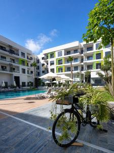 a bike parked in front of a swimming pool at Le Jardin Secret - Pool View Elegance in Mohammedia