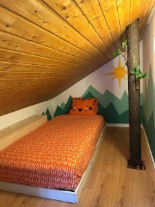 a bedroom with a bed under a tree at Ovronnaz , 2 pièces appartement Marana in Ovronnaz +1 photo