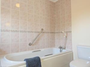 a bathroom with a bath tub and a toilet at Apple Cottage - Emsworth in Emsworth +23 photos
