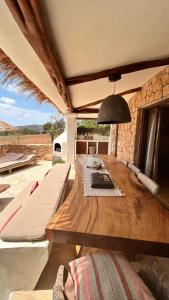 a wooden table in a room with a view at SERENITY pool Ibiza Villa in Santa Eularia des Riu