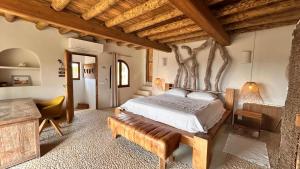 a bedroom with a bed and a desk in a room at SERENITY pool Ibiza Villa in Santa Eularia des Riu +72 photos