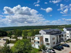 an apartment complex with cars parked in a parking lot at Astrum Apartman in Egerszalók