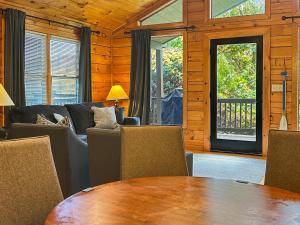 a living room with a table and a couch at Free Railroad Tix - secluded - Fire Pit and Outdoor Bed Swing in Talc Mountain