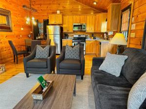 a living room with a couch and chairs and a kitchen at Free Railroad Tix - secluded - Fire Pit and Outdoor Bed Swing in Talc Mountain