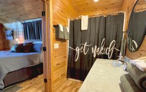 a bedroom with a bed and a tub in a room at Free Railroad Tix - secluded - Fire Pit and Outdoor Bed Swing in Talc Mountain +15 photos