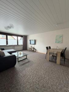 a living room with a table and a couch at Gemütliche Ferienwohnung in Worbis in Worbis