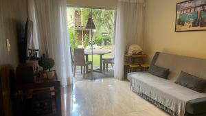 a living room with a couch and a table at Villas do Pratagy-Tulipa 1101 in Maceió