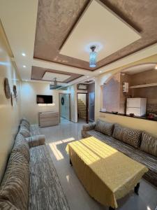 a living room with a couch and a table at Quiet Aourire Hideway in Aourir +8 photos
