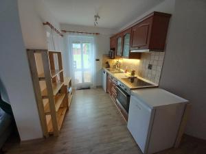 a kitchen with brown cabinets and a white refrigerator at Apartmán Eskadra 1 in Horní Malá Úpa +15 photos