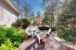 a group of chairs and a table in a yard at Salty Way in Ocean Pines