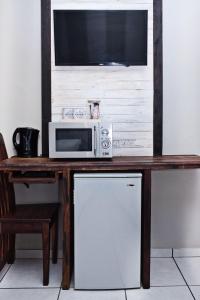 a microwave oven sitting on top of a wooden table at Rundu B&B in Rundu