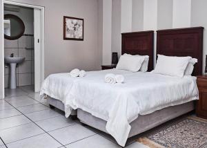 a bedroom with a large bed with towels on it at Rundu B&B in Rundu +12 photos