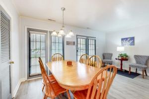 a dining room with a wooden table and chairs at Drawbridge Rd 38 in Ocean Pines