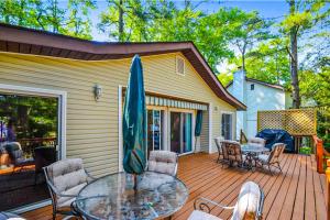 a patio with a table and chairs on a deck at Drawbridge Rd 38 in Ocean Pines