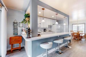a kitchen with a counter and stools in a room at Drawbridge Rd 38 in Ocean Pines