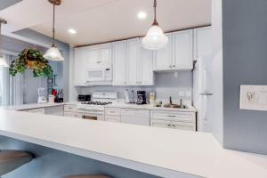 a kitchen with white cabinets and a white counter top at Drawbridge Rd 38 in Ocean Pines