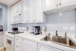 a white kitchen with white cabinets and a sink at Drawbridge Rd 38 in Ocean Pines +16 photos
