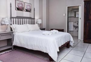 a bedroom with a large white bed with towels on it at Rundu B&B in Rundu