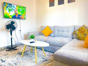 a living room with a couch and a table at KL beach road Diani in Ukunda