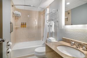 a bathroom with a sink and a toilet and a shower at Best Western PLUS Franklin Square Inn in Troy +84 photos