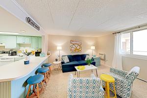 a kitchen and a living room with a blue couch at Colonial Unit 202 in Ocean City